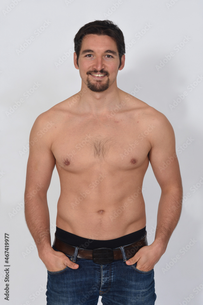 portriat of a man shirtless smiling and hands on pocket on white background portriat of a man shirtless smiling and hands on pocket on white background