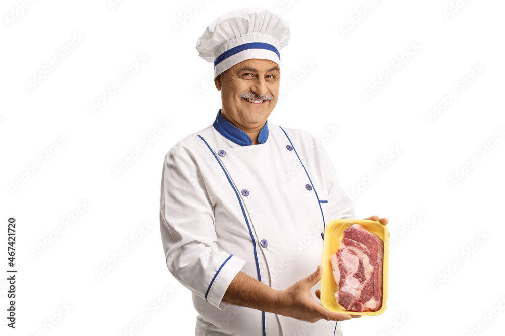 Mature male chef holding a packed raw steak Mature male chef holding a packed raw steak