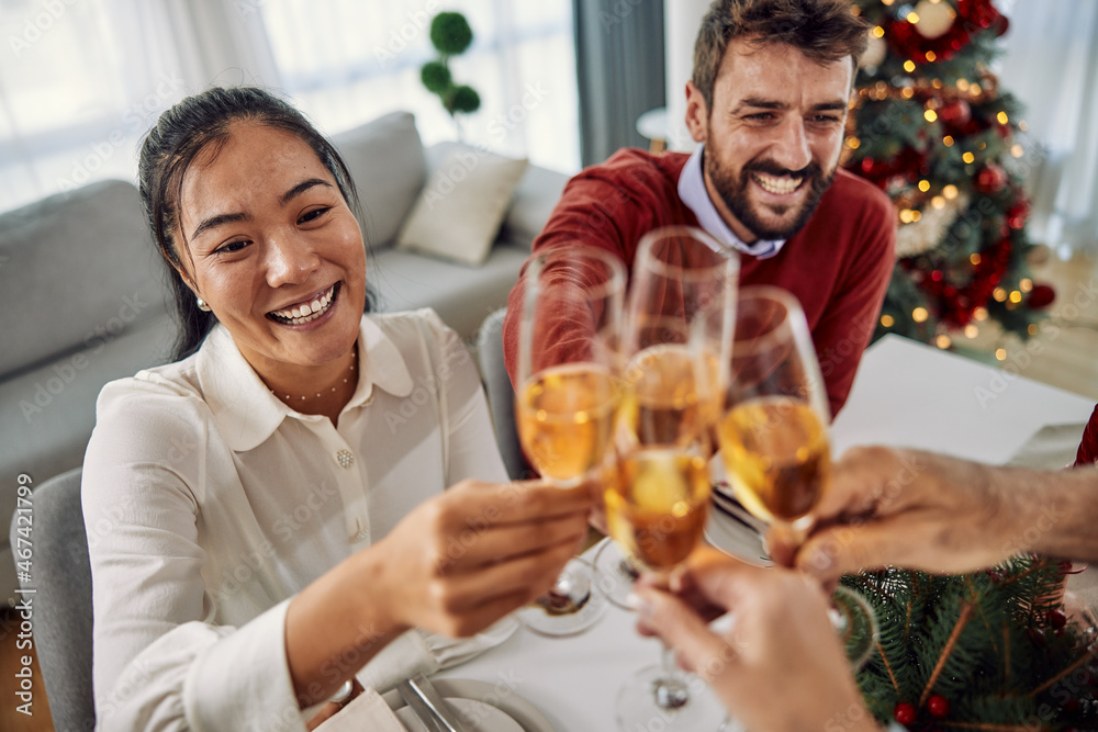 Family toasting at christmas dinner in the dining room