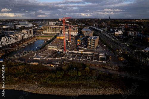 Kade Zuid construction site part of the new Noorderhaven neighbourhood at riverbed of the IJssel in Zutphen, The Netherlands. Aerial industrial view of building plot. Housing and urban management.