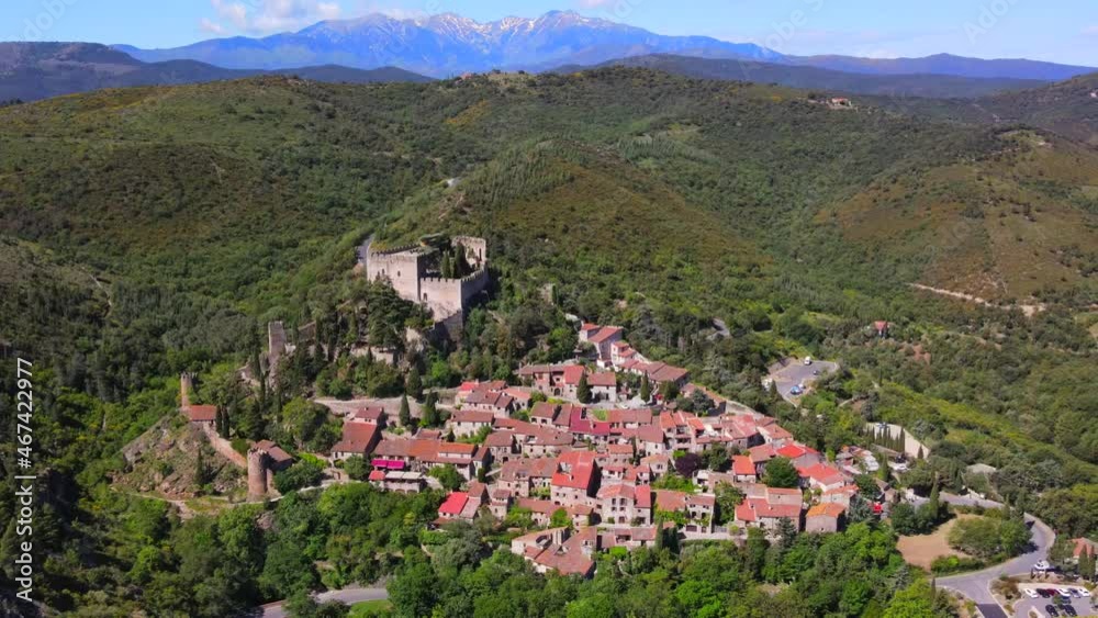 Aerial view of the village of Castelnou at the base of the Pyrenees Mountains in French Catalonia Aerial view of the village of Castelnou at the base of the Pyrenees Mountains in French Catalonia