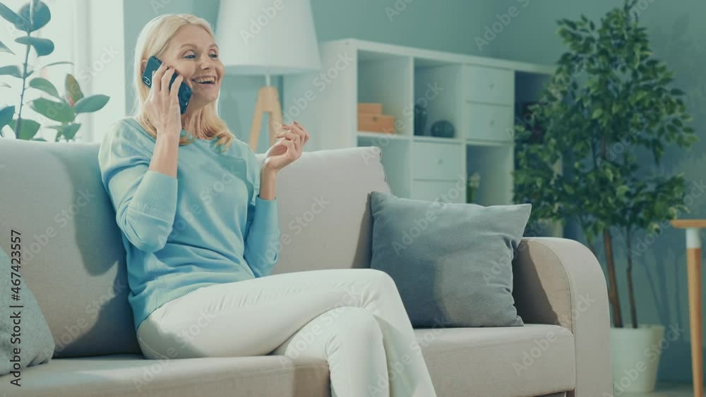 Sociable friendly lady sit sofa enjoy weekend conversation laugh rejoice Sociable friendly lady sit sofa enjoy weekend conversation laugh rejoice