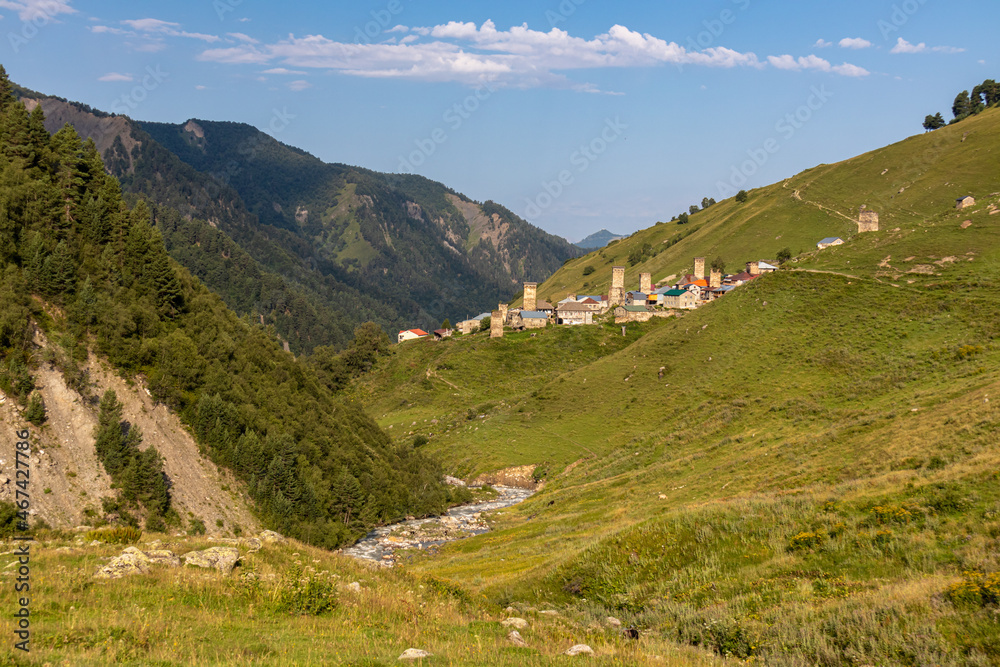 Panoramic view on Adishi, a mountain village, located in the High Caucasus, Svaneti Region in Georgia. Svan watch towers can be seen. A hiking trail and a river leads to the village. Solitude