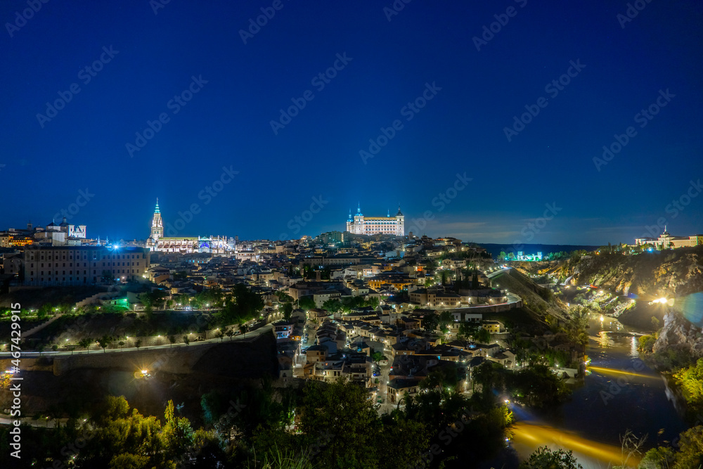 Night Photo of the Alcazar de Toledo and The Cathedral of Toledo with the Tagus River Around them