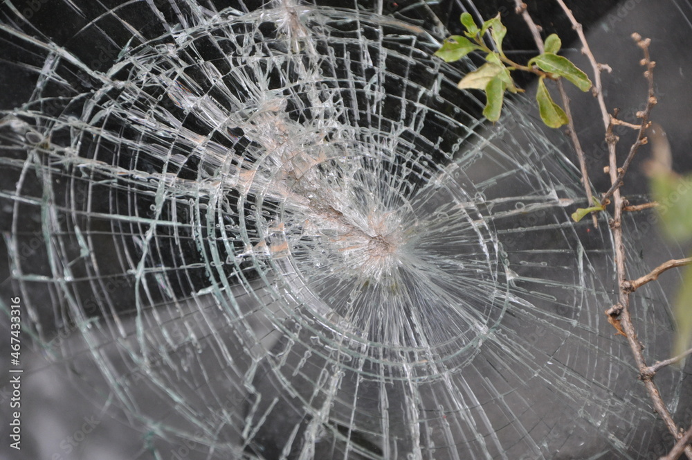 Abstract image of broken glass texture. Close-up broken car windshield. Broken and damaged car. Broken urban abandoned car window, circles, abstract