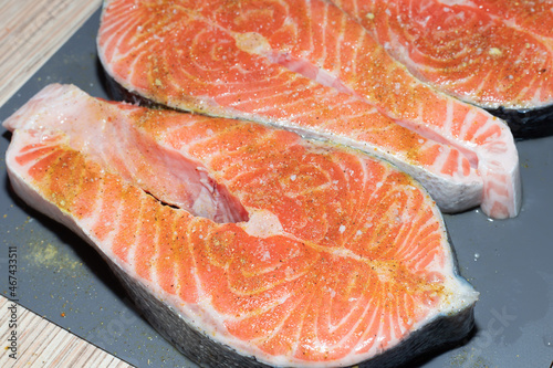 Raw salmon with salt ready to cooking top view on kitchen table