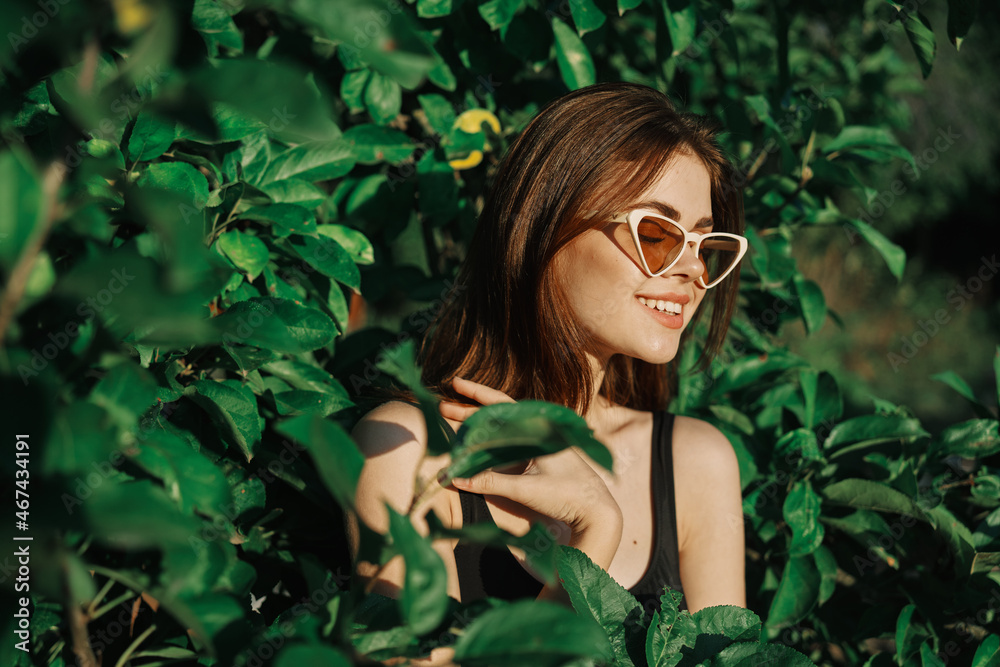 smiling woman wearing sunglasses green leaves nature fashion smiling woman wearing sunglasses green leaves nature fashion
