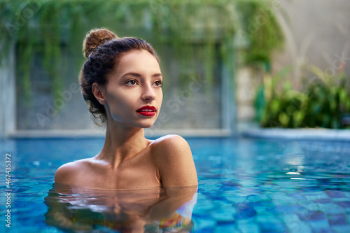 Retreat and vacation.. Beautiful young woman relaxing in spa swimming pool. © luengo_ua