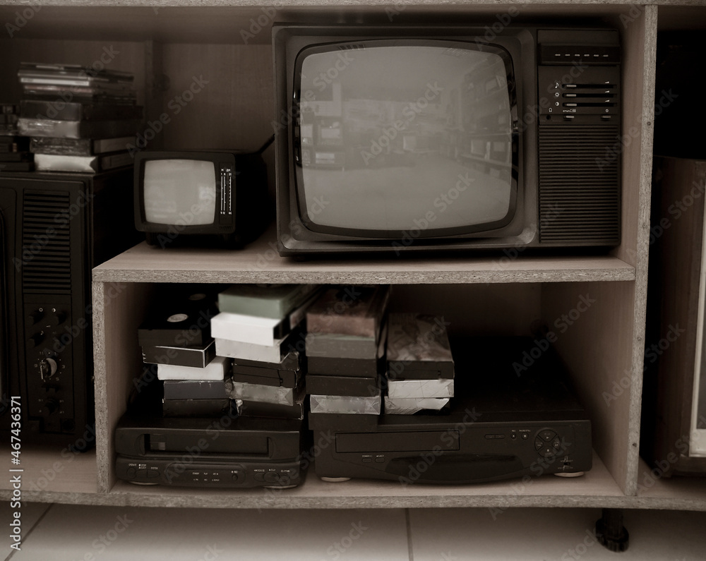 markt Welvarend pedaal Old video recorder and tv . Vintage Video VHS Player on the shelf. VHS  cassette and DVD disc. Stock Photo | Adobe Stock