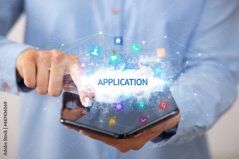 Businessman holding a foldable smartphone, technology concept Businessman holding a foldable smartphone, technology concept