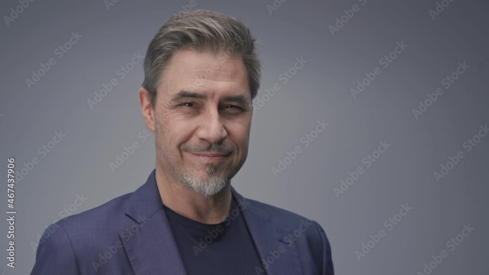 Business portrait - businessman smiling. Mature age, middle age, mid adult man in 50s with gray hair and happy confident smile. Copy space. Business portrait - businessman smiling. Mature age, middle age, mid adult man in 50s with gray hair and happy confident smile. Copy space.