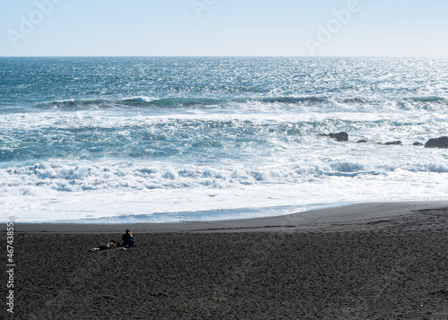Panoramic view of infiernillo beach in pichilemu with two young women enjoying the sun.