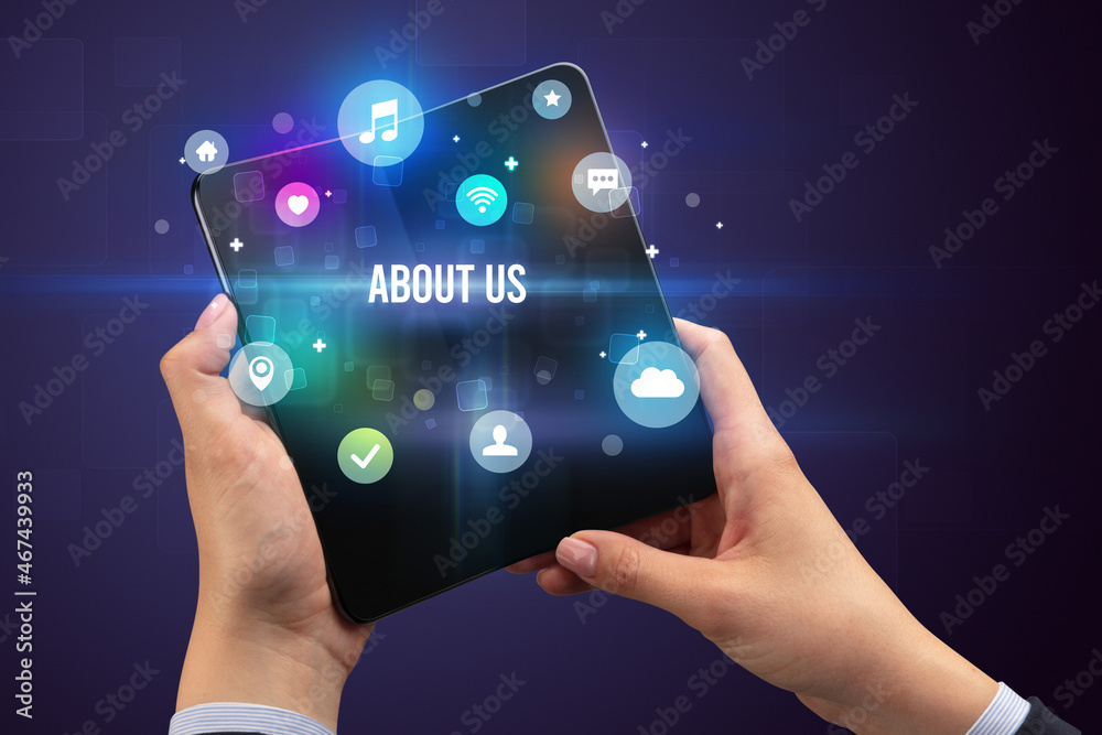 Fototapeta premium Businessman holding a foldable smartphone