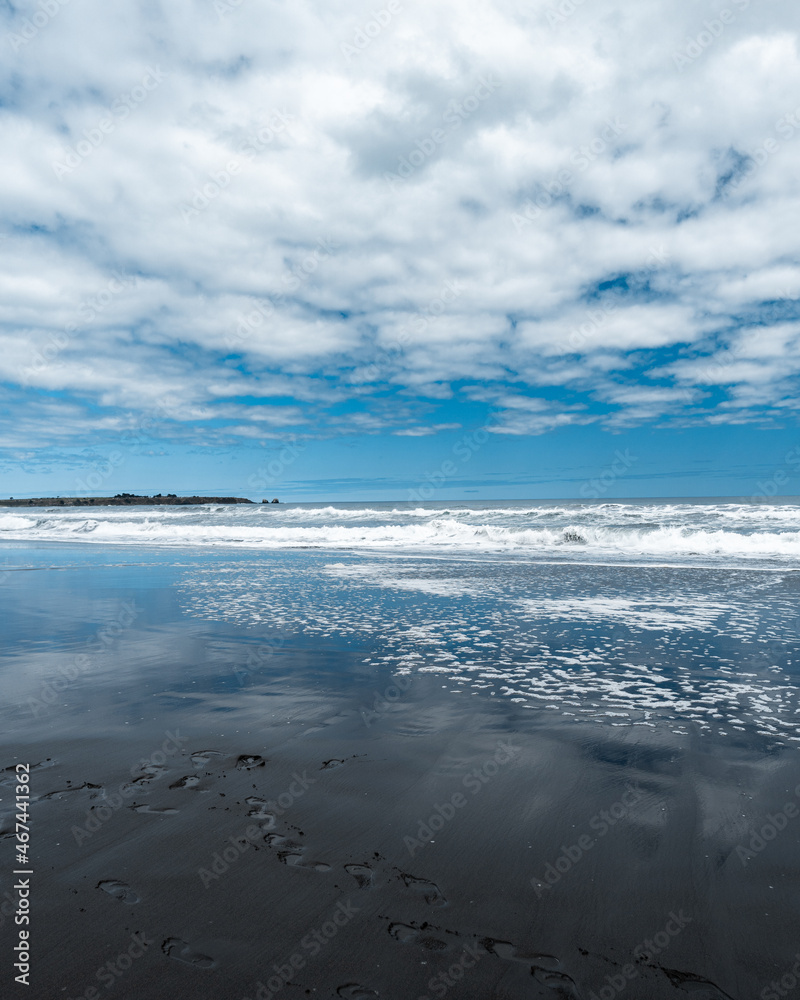 Pichilemu's Infiernillo beach with its black sand on a cloudy day.