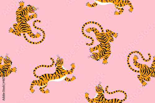 Fototapeta Naklejka Na Ścianę i Meble -  Seamless pink exotic pattern with cute cartoon tiger silhouettes. Vector illustration. Circus animal fabric ornament print.