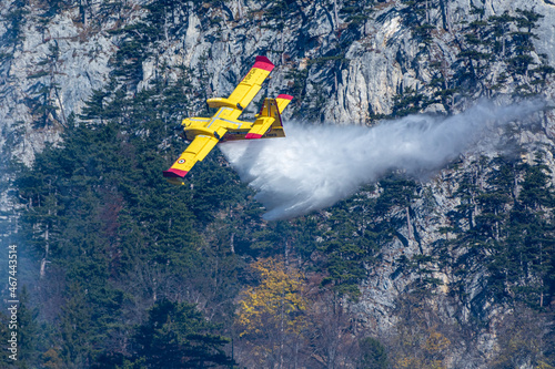 An italien Canadair plane drops water during a forest fire in Hirschwang, Austria photo