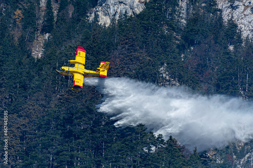 An italien Canadair plane drops water during a forest fire in Hirschwang, Austria