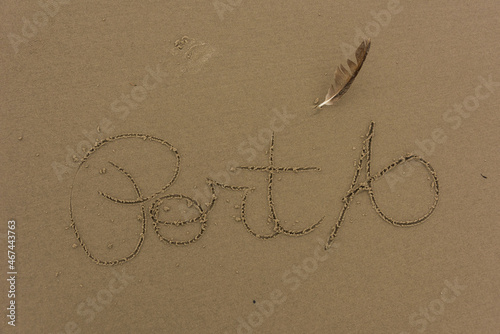 Handwriting in sand on beach stating 