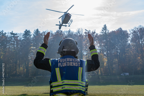 A Fire Department Marshaller is Marshalling signal for Helicopter during a forest fire in Hirschwang, Lower Austria