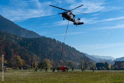 Obraz na płótnie Firefighters fill a water Bucket of an Austrian Armed Forces S-70