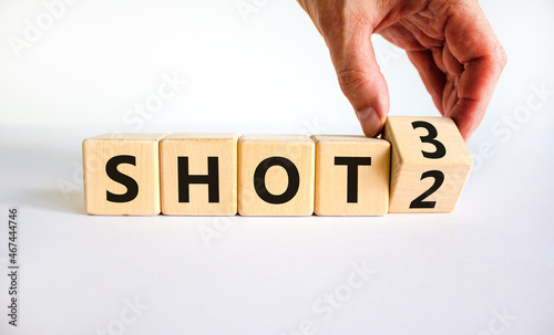 Covid-19 booster dose vaccine shot symbol. Doctor turns cubes and changes words 'shot 2' to 'shot 3'. Beautiful white table, white background, copy space. Covid-19 booster dose vaccine shot concept.