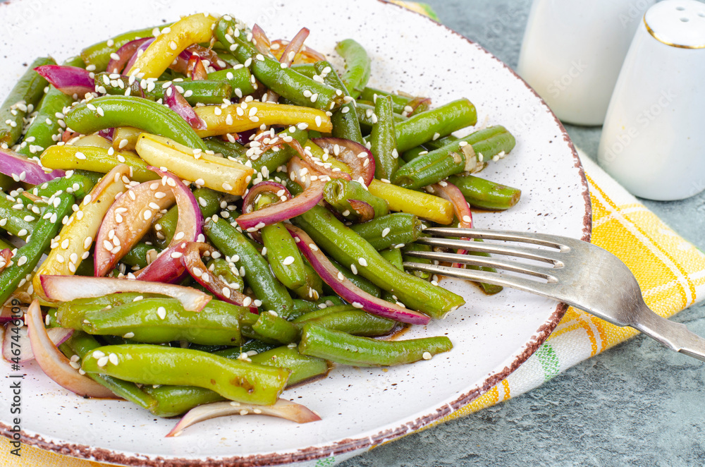 Vegetarian green bean pod dish with red pickled onions and sesame seeds. Studio Photo Vegetarian green bean pod dish with red pickled onions and sesame seeds. Studio Photo