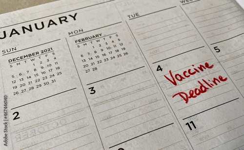 Fotografija Marking the calendar for the January 4th US national deadline for large companies to mandate the COVID-19 vaccine for employees or submit to weekly testing