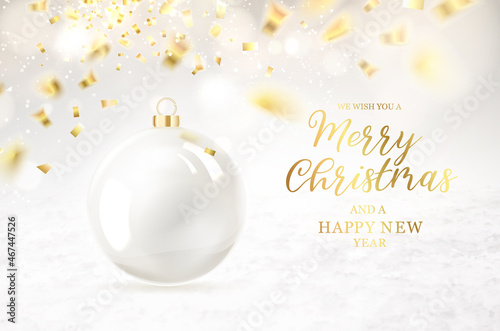 Merry christmas greeting card with lettering. Golden confetti falls on the background. Happy new year . Christmas ball.