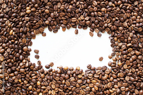 background from coffee beans on a white table. Coffee time. kind of sveru. flat lay. space for inspirational text. 