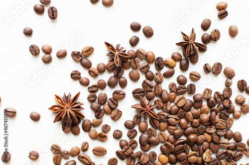 scattered coffee beans and star anise on a white background. kind of sveru. flat lay. space for inspirational text. coffee time.
