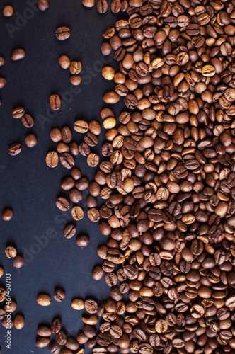 roasted aromatic coffee beans on a dark background. coffee background. flat lay with place for text. view from above. 