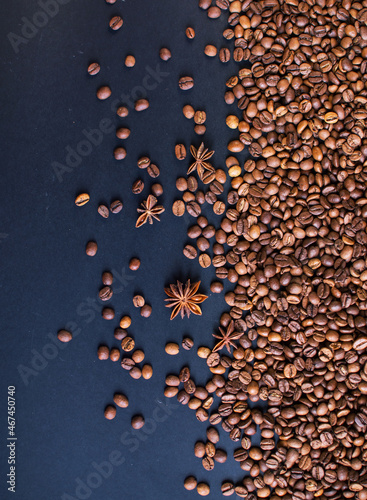 roasted aromatic coffee beans and star anis on a dark background. coffee background. flat lay with place for text. view from above. 