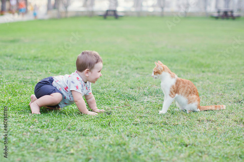 Baby child and ginger cat walking © aprilante