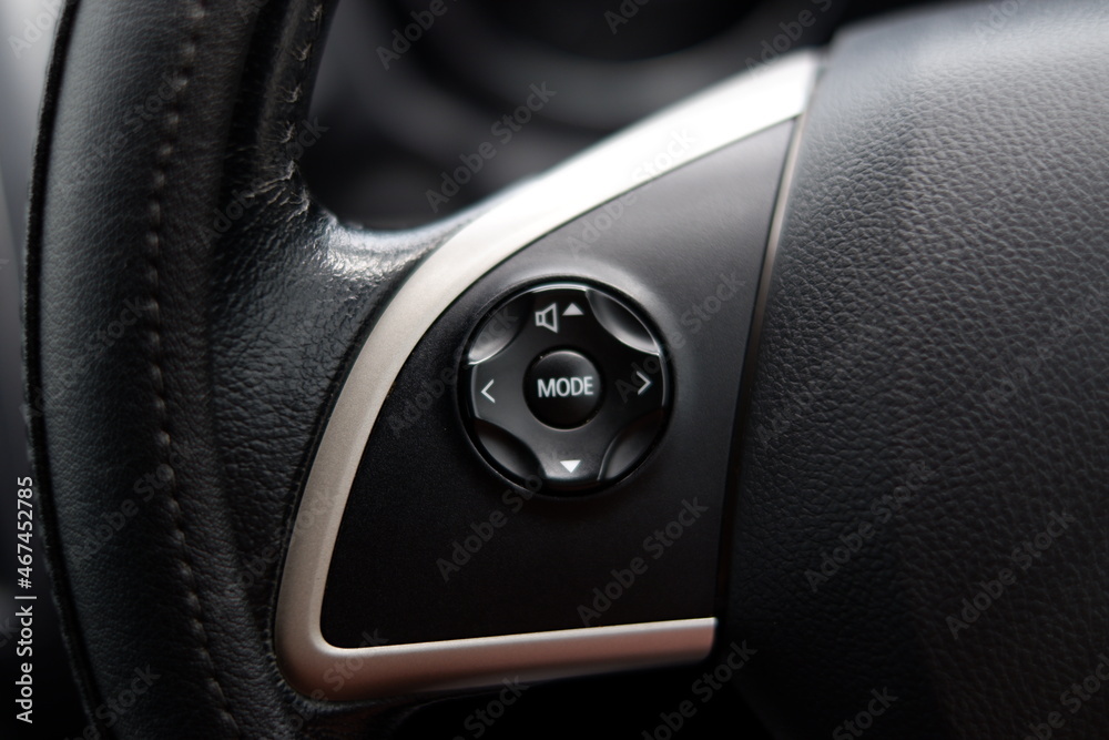 close-up photo of the multimedia buttons on a steering wheel