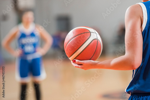 Woman keeps the ball during basketball match. © Dziurek