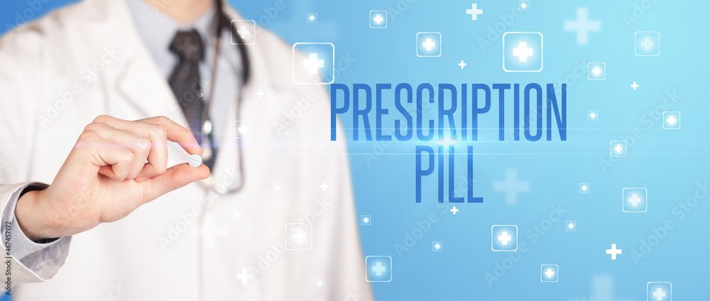 Close-up of a doctor giving a pill Close-up of a doctor giving a pill