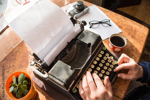 Male writer writing his book on an old antique typewriter. An old antique typewriter.