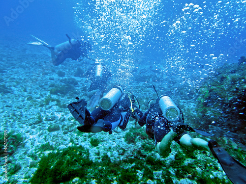 scuba divers at Ressureta diving point in Fernando de Noronha archipelago, State of Pernambuco, Brazil photo