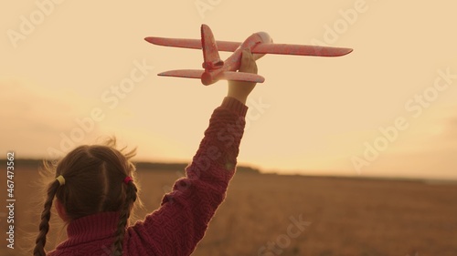 happy child runs sunset with toy airplane his hand, childhood dream flying, kid soars air fantasizing pallets, being an air transport pilot, flying wings up, girl running presenting wings light sun