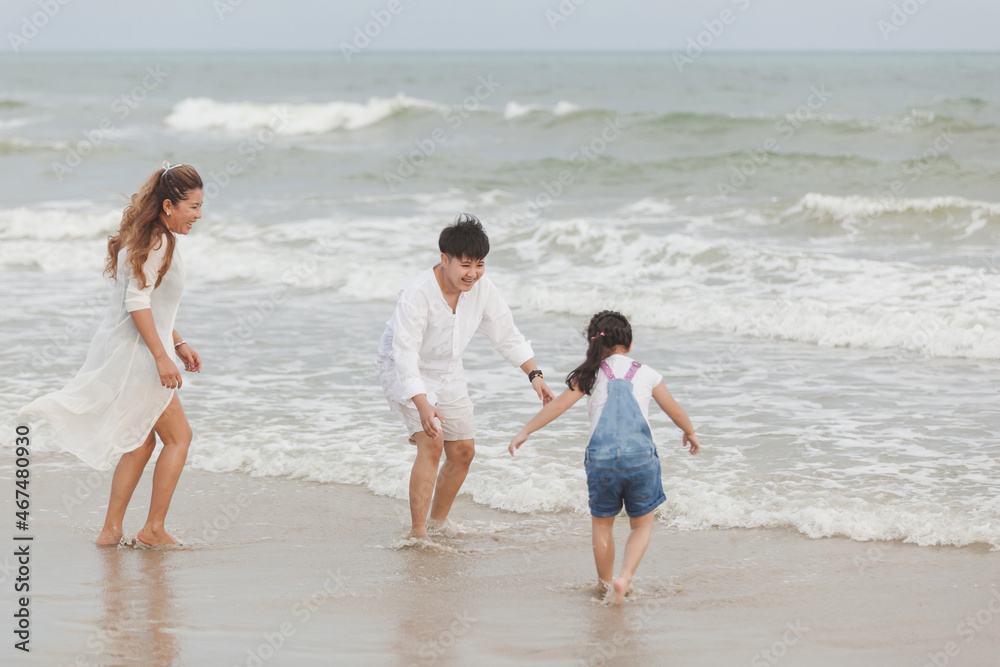 Happy family having fun running on beach. Relaxing holiday concept. Travel attention Happy family having fun running on beach. Relaxing holiday concept. Travel attention