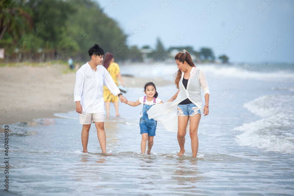 Happy family having fun running on beach. Relaxing holiday concept. Travel attention