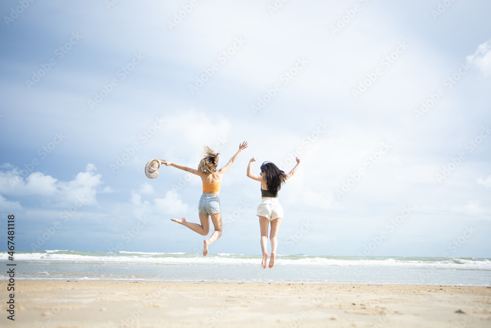 happy young woman jumping on the beach. woman jumping on the beach at the sea in the sunny day. Travel summer concept