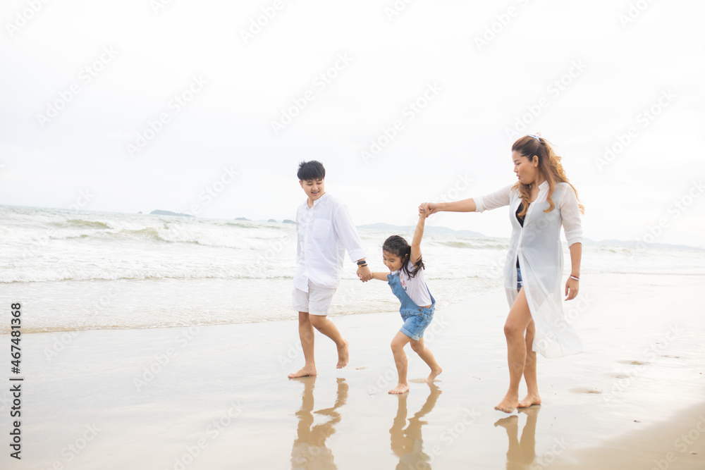 Happy family having fun running on beach. Relaxing holiday concept. Travel attention