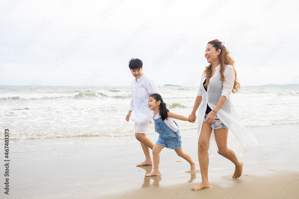 Happy family having fun running on beach. Relaxing holiday concept. Travel attention Happy family having fun running on beach. Relaxing holiday concept. Travel attention
