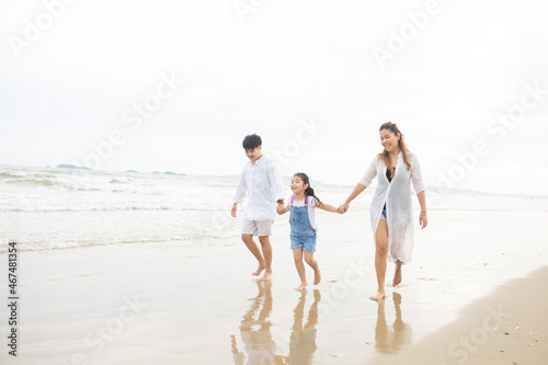 Happy family having fun running on beach. Relaxing holiday concept. Travel attention