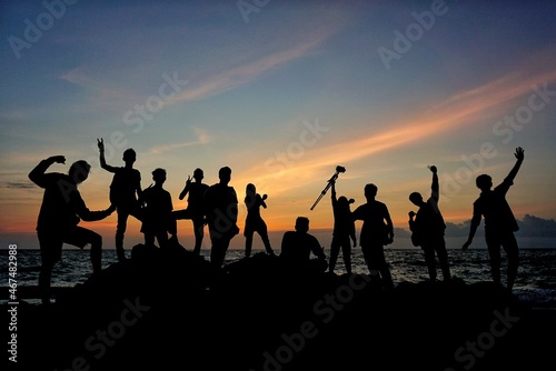 people on the beach at sunset © Syukra