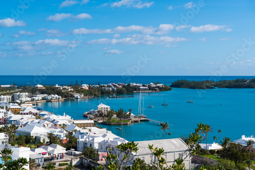 Bermuda s Coastal Symphony  Where azure waters meet vibrant skies  lush landscapes cradle charming houses  creating a harmonious island masterpiece.