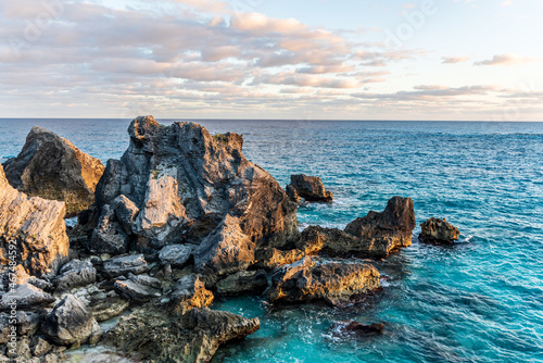 Tobacco Bay's Coastal Charm: St. George's, Bermuda; where sturdy rocks frame azure waters, a picturesque blend of nature's beauty. photo