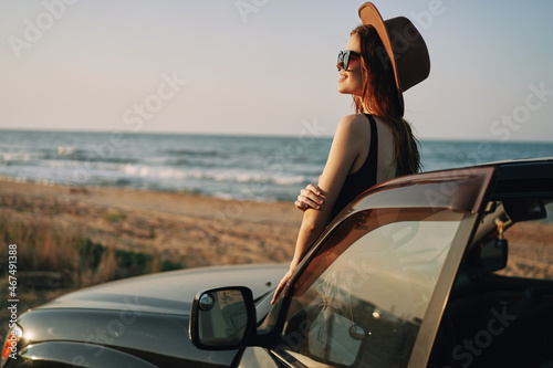 pretty woman in sunglasses near the car on the beach travel lifestyle