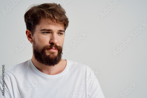 bearded man pain in the neck health problems massage therapy light background